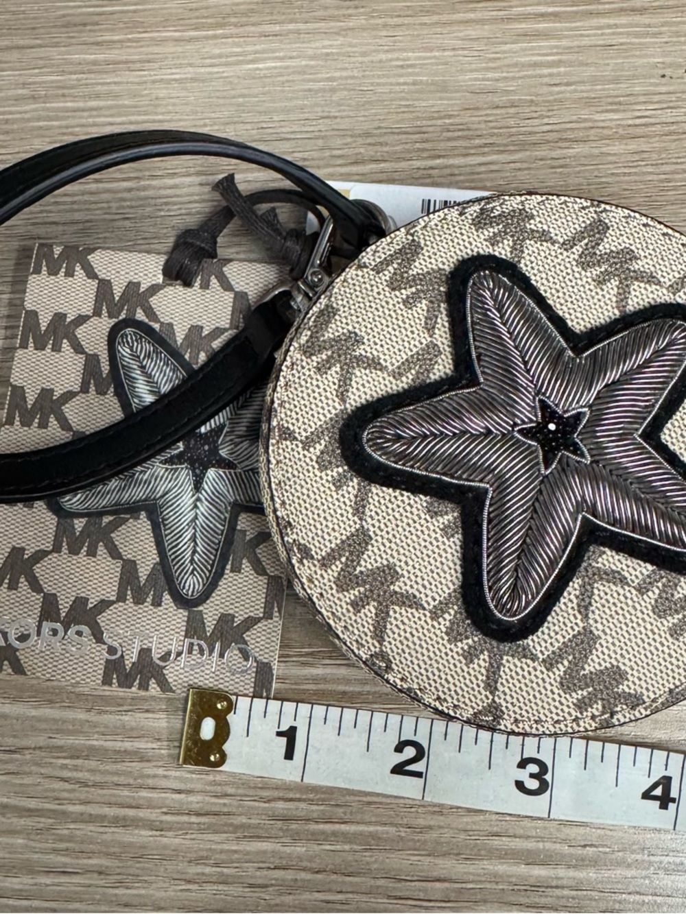 Michael Kors Beige Canvas Round Wristlet with Black Star Appliqué